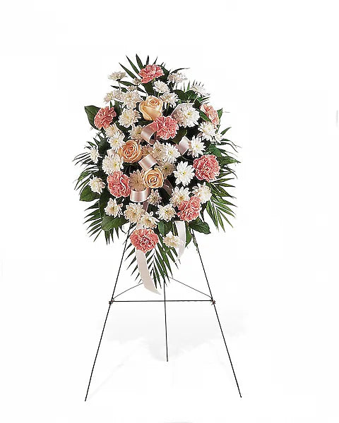 Pink and white blooms arranged beautifully on stand with white backdrop