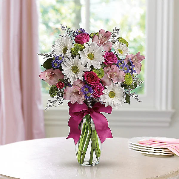 Charming floral arrangement in clear vase for home decor.