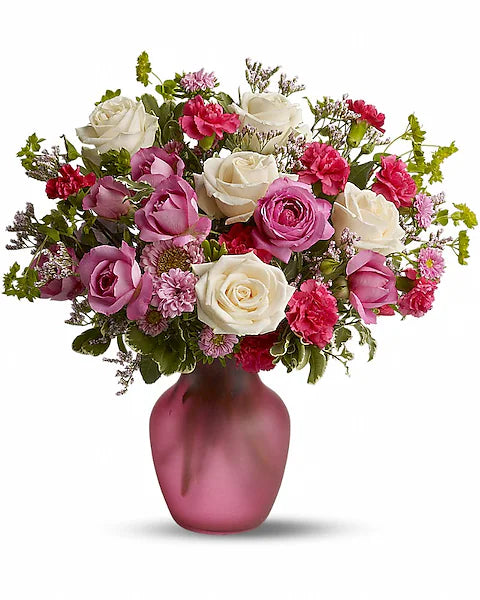 Bouquet of pink and white flowers in a pink vase