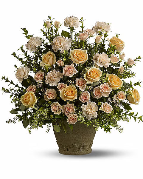 Bouquet of yellow, off-white, and beige-pink roses in decorative pot
