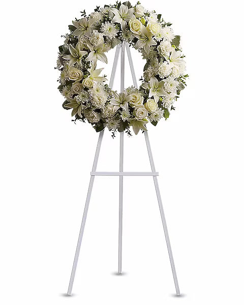 Decorative white flower wreath on display stand