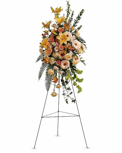 Floral centerpiece with yellow blooms and green foliage on stand