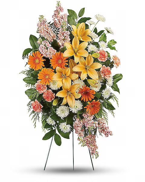 Colorful flower arrangement with yellow lilies, orange gerberas, and pink flowers 