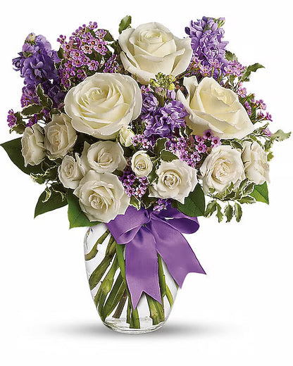 Bouquet of white roses and purple flowers