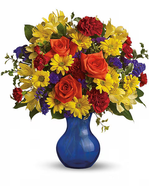 Colorful bouquet of flowers in a blue vase on a white background