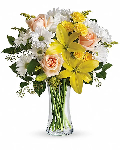 Yellow lilies, white daisies, pink roses in glass vase